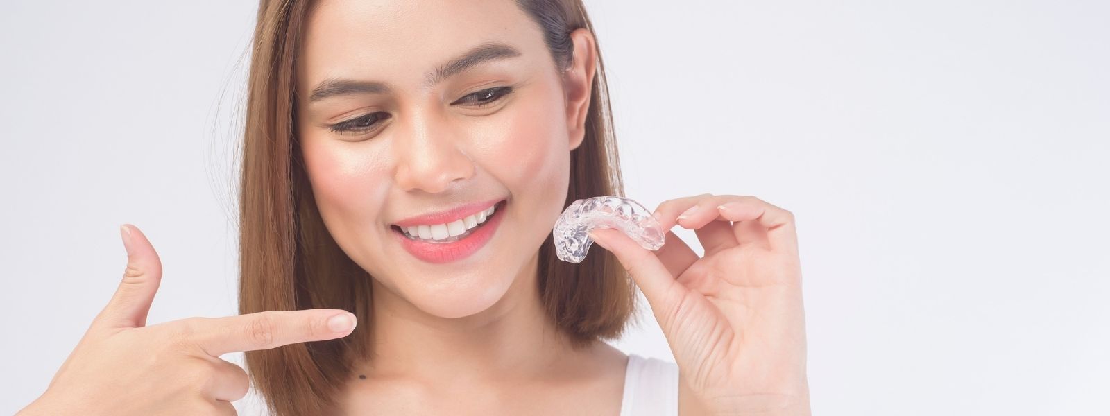 A Girl pointing at Invisalign in Oaks