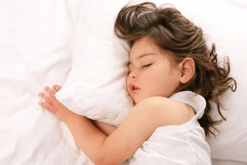 child sleeping on pillow